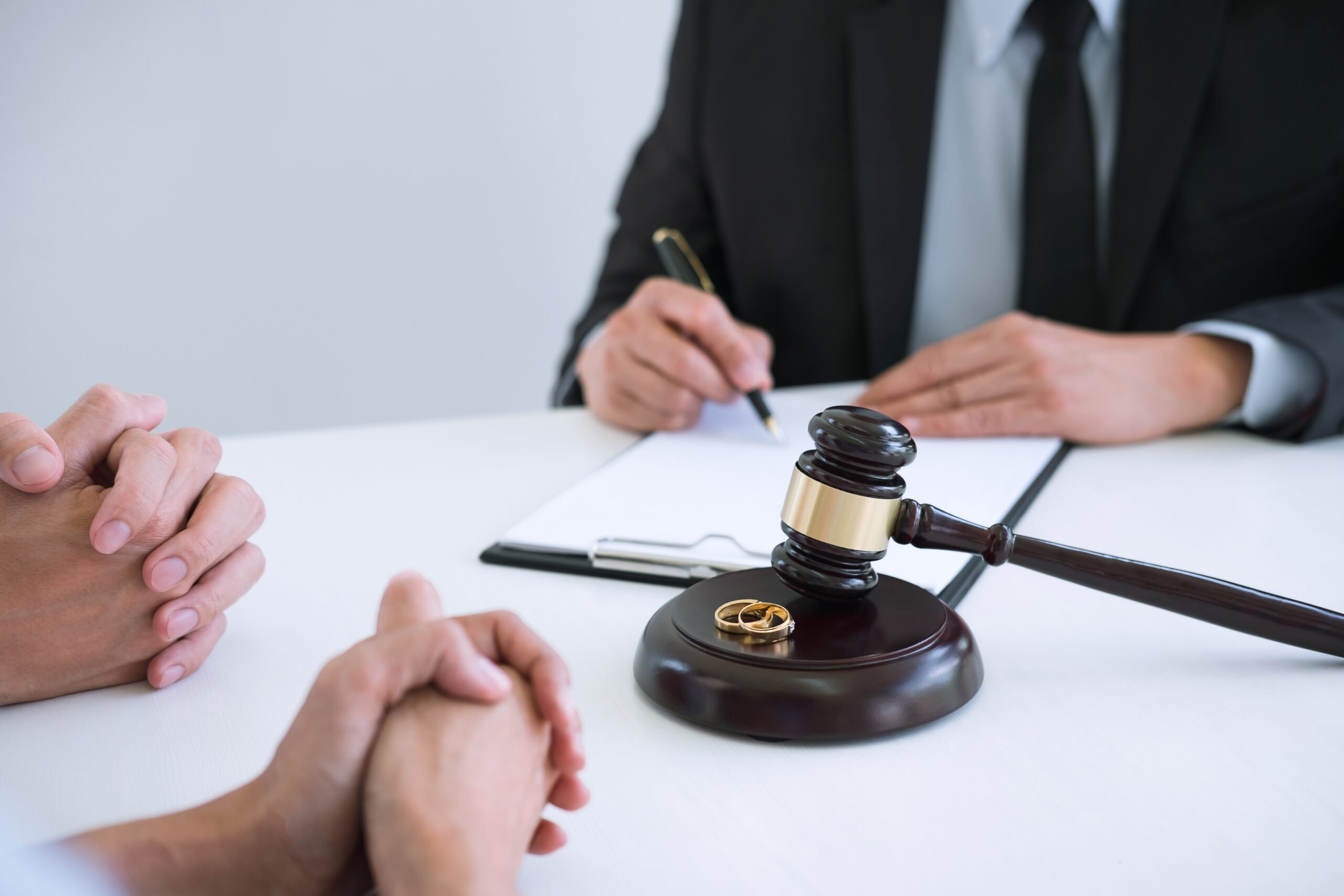 Agreement prepared by lawyer signing decree of divorce (dissolution or cancellation) of marriage, husband and wife during divorce process with male lawyer or counselor and signing of divorce contract.