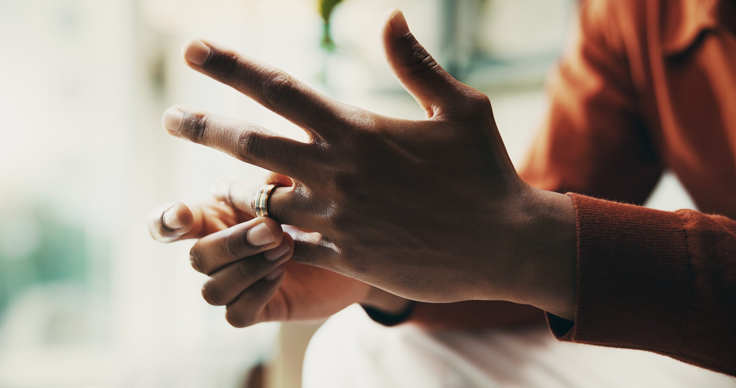 Hands, man and conflict as divorce, stress and anxiety for mental health, wellness and counselling. Male person, mistake and frustrated in psychology with depression, therapy and wedding ring in home.