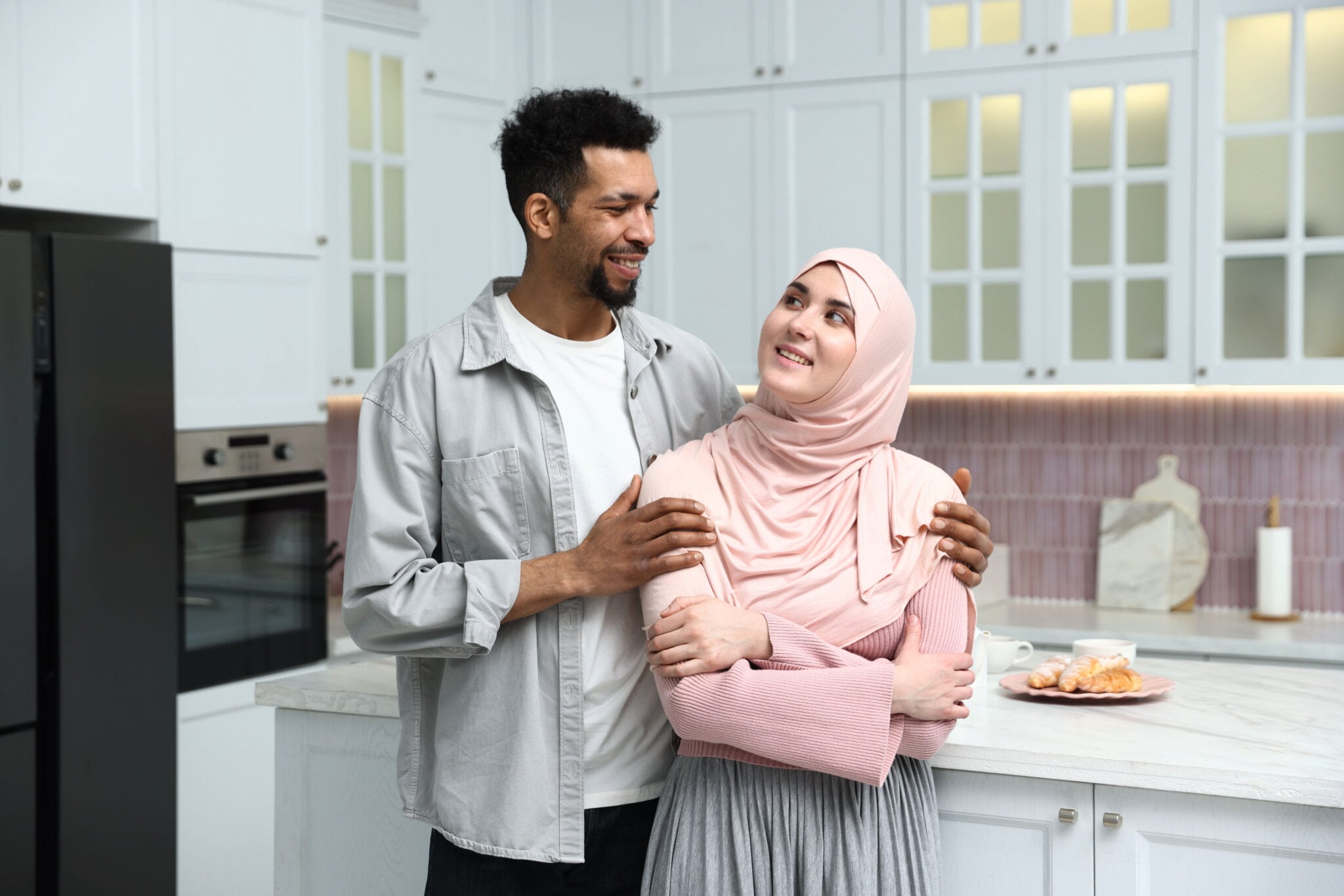 Happy muslim couple spending time together in kitchen